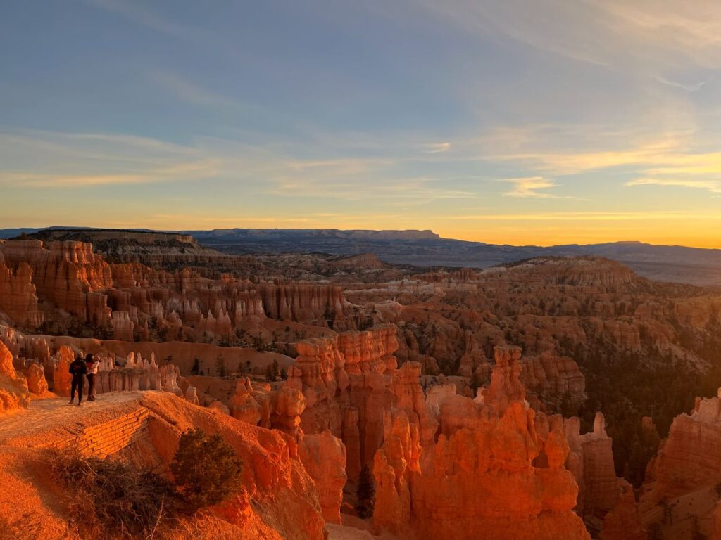 Sunrise from Navajo loop in Bryce Canyon illuminating amphitheater.