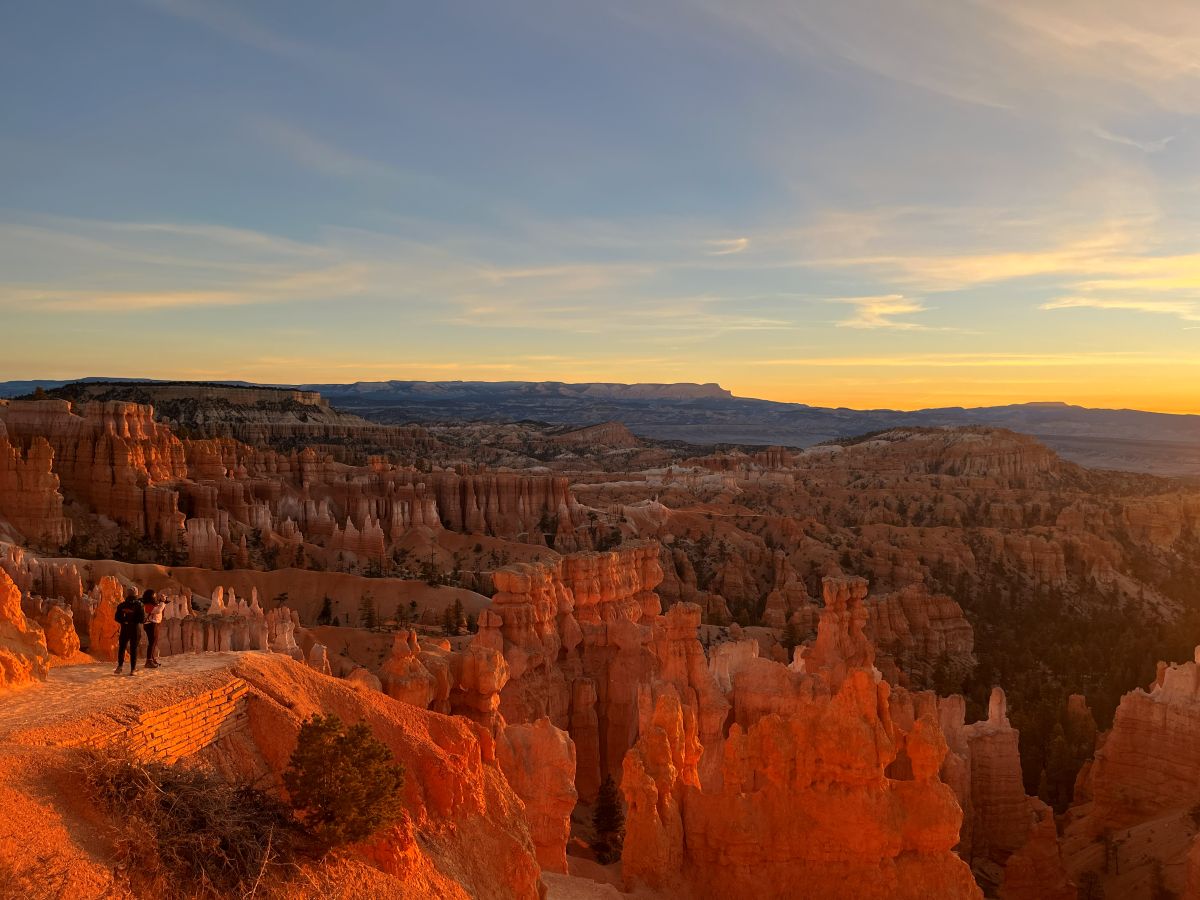 Sunrise from Navajo loop in Bryce Canyon illuminating amphitheater.